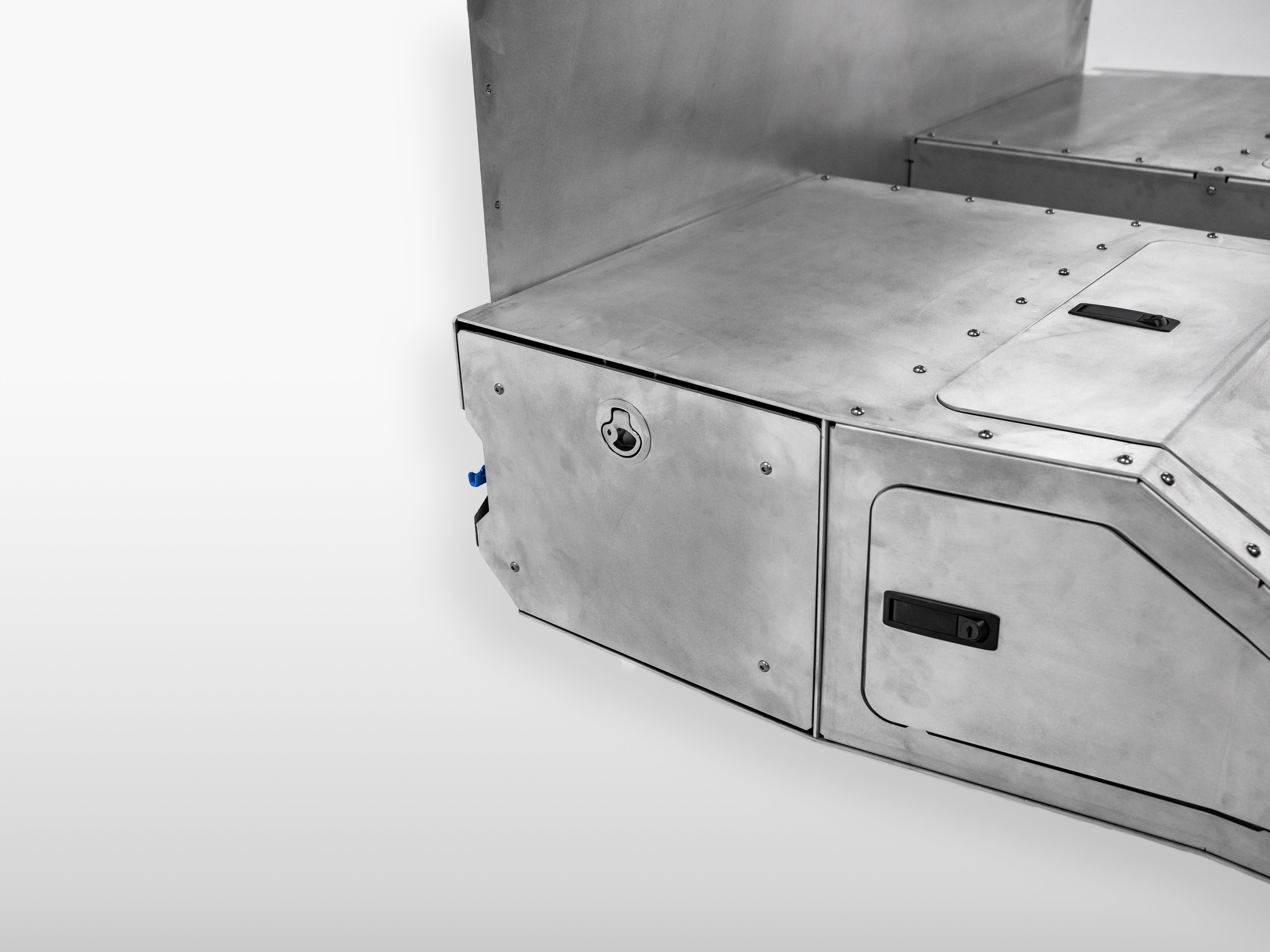 Close-up of The Highway Tight aluminum storage drawer with integrated locking latch.