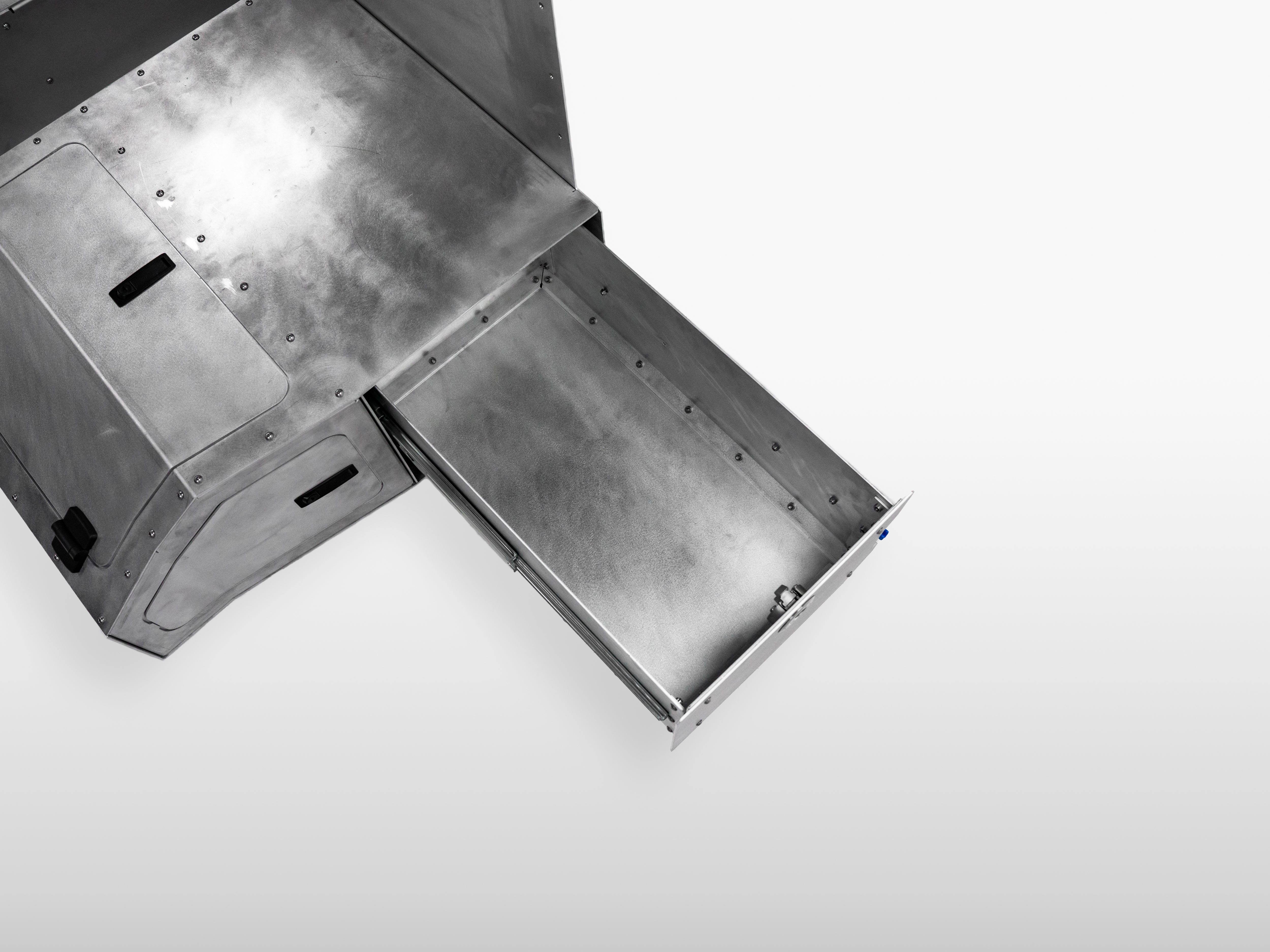 Close-up of The Highway Tight aluminum storage drawer with integrated locking latch.