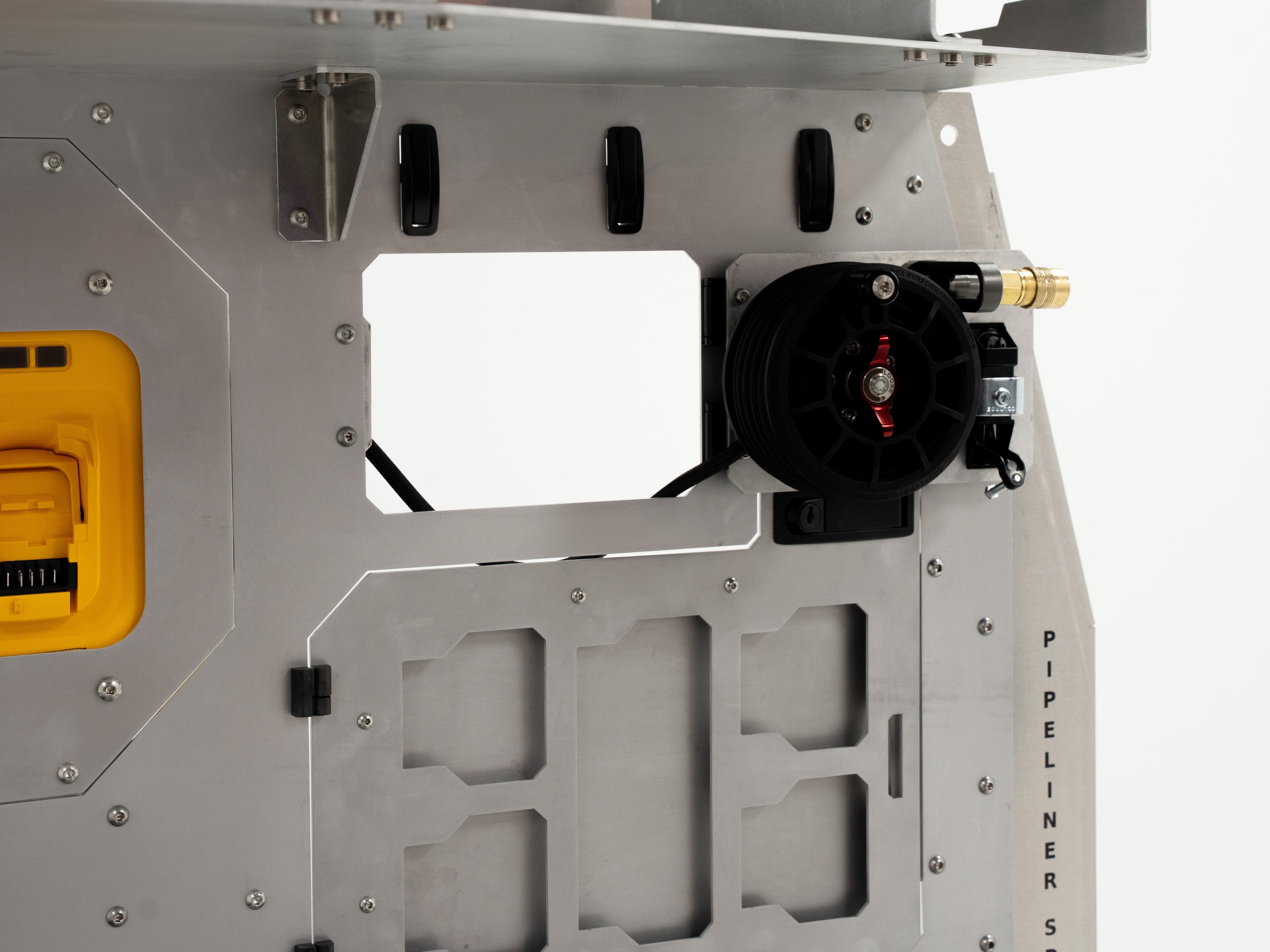 Side view of The Pipeliner Special aluminum storage wall featuring mounted hose reel and outlet panel.