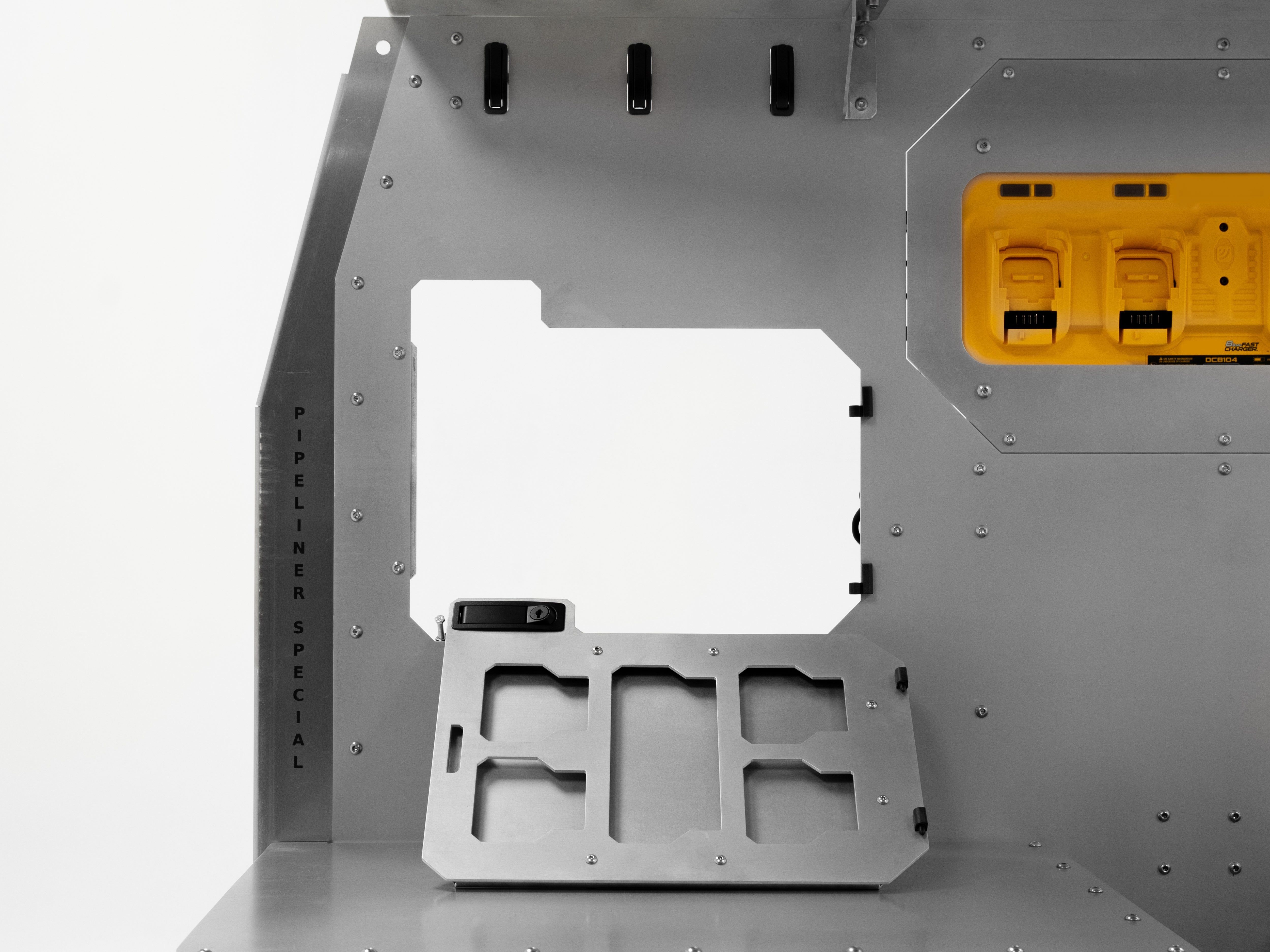 Service access cutout on The Pipeliner Special showing modular wiring ports and outlet mounts.
