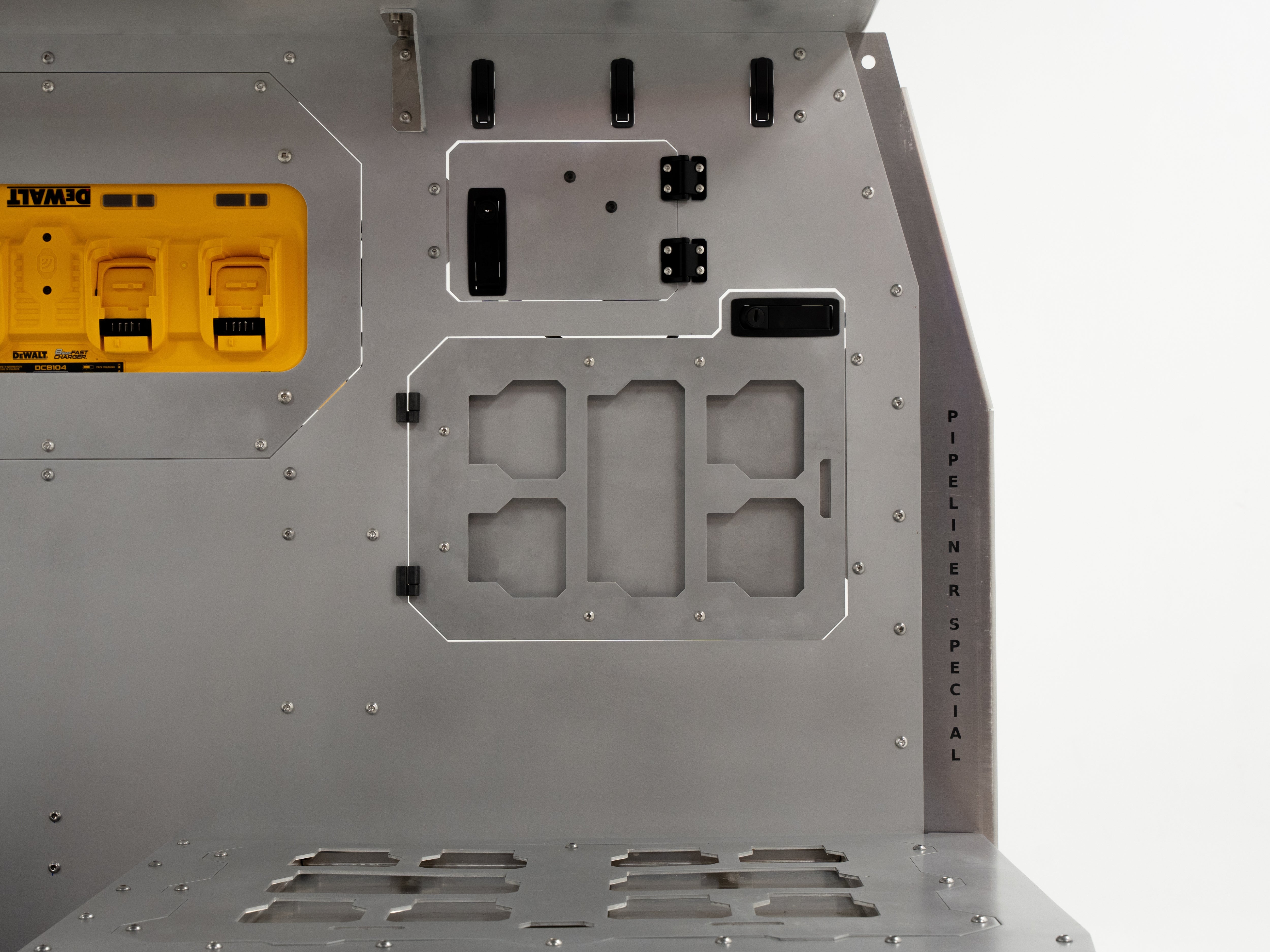 Close-up of The Pipeliner Special’s aluminum panel featuring outlet and vent cutouts.